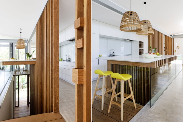 The kitchen area is connected – both visually and spatially – to the adjacent living and dining areas.