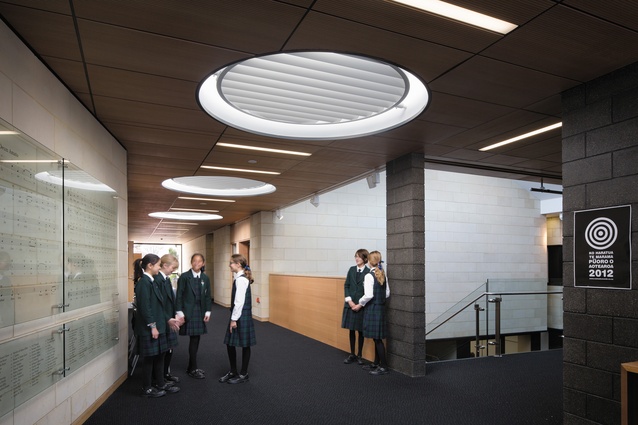 Louvred circular skylights draw sunlight into the corridors.
