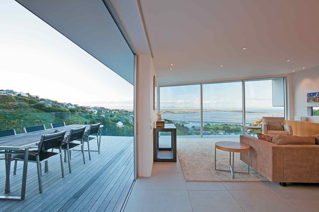 The floor-to-ceiling glazing in the living area looks out to views of the estuary.