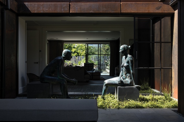 A courtyard is tucked between the garage, gallery and the main living area. In it, there is a bronze sculpture of two figures by Australian sculptor Cezary Stulgis.