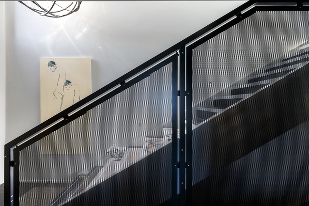 The perforated motif is carried through to an internal stair railing.
