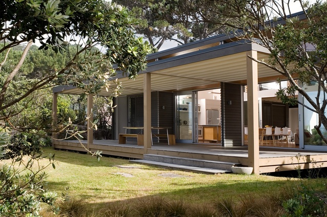 Whangapoua Bach, built in 2008. This simple bach sits lightly on the sand dunes, with most of the living and entertaining taking place on two large verandahs.