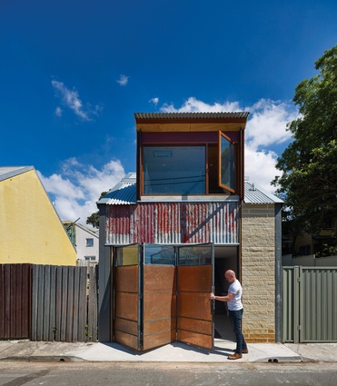 The studio fronts a rear laneway; a pivoting screen works as a garage door or a privacy/ventilation screen, depending on how the space is used.