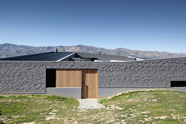 Lake Hawea Courtyard House, Otago by Glamuzina Paterson. Responding to historical precedents, the use of brick and the low singular form anchors the house firmly to its site.