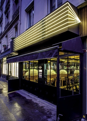 Passersby are drawn to Le Cloche, in St-Germain des-Prés, by a black canopy outlined with neon lights.