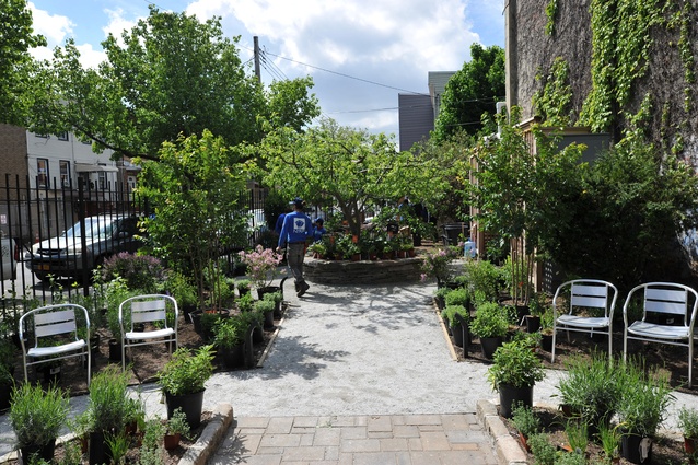 Essex Street Community Garden, after. A series of large, raised planting beds enclosed by low stone walls provide ample space for cultivating vegetables and herbs.