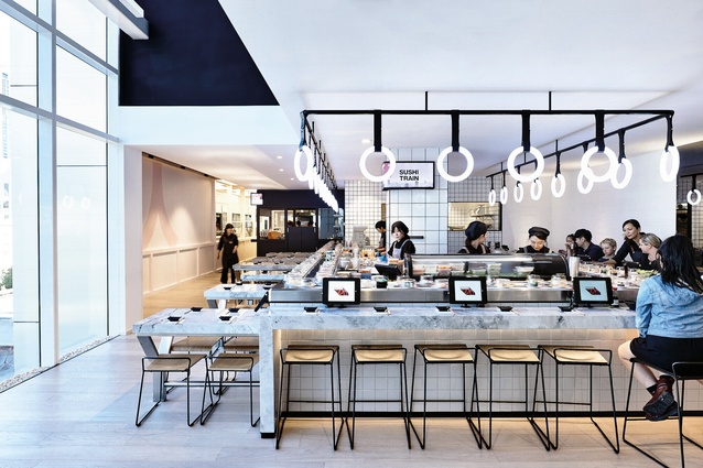 The design of the sushi tran was inspired by subway stations. It features subway tiles and glowing led rings that are reminiscent of train handles.