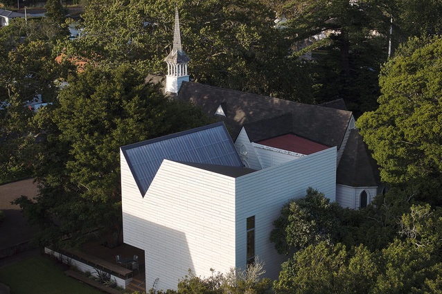 Replacing messy 1960s’ additions, the project is tucked tightly between a heritage church, established trees and historic stone walls.