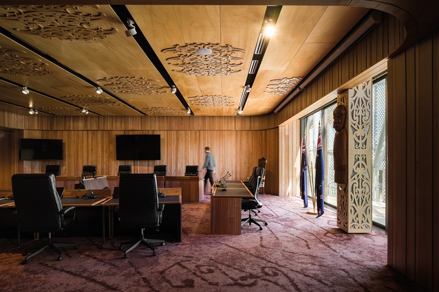 The interior surfaces of the civic chamber weave together carpeted local geographic references with carved rich native timbers.