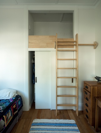 A built-in snug above the wardrobe provides the children with a fun space to play.
