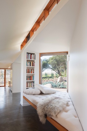An angled nook opposite the study holds an intimate day bed for reading, taking in the view of the garden and basking in the northern light.