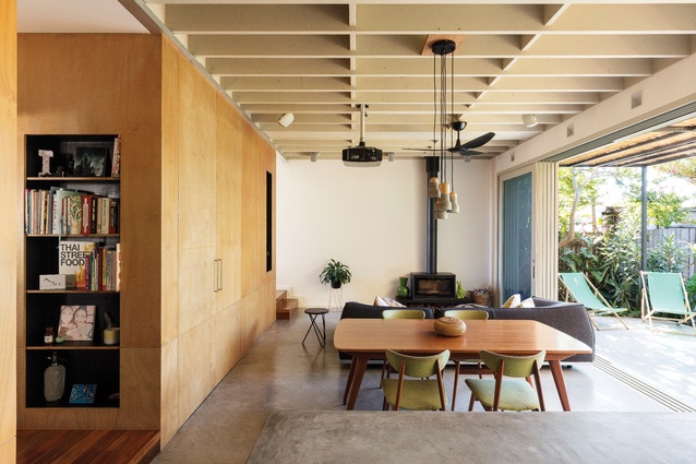A money-saving strategy to expose structural beams provides depth and rhythm to the room.