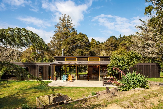 Easterbrook House, Titirangi, Auckland, 2014. The home is elongated like a train and clad in black board-and-batten to offer a rural vibe.