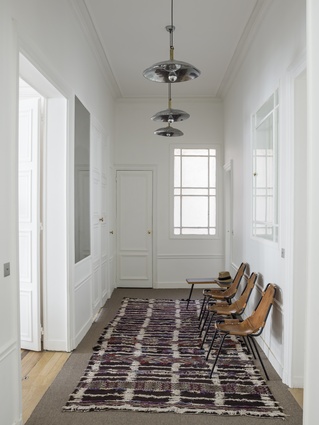 The three hallway chairs are by Charlotte Perriand.