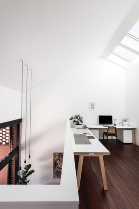 A void to the lower level provides connection and transparency between adjacent living spaces.