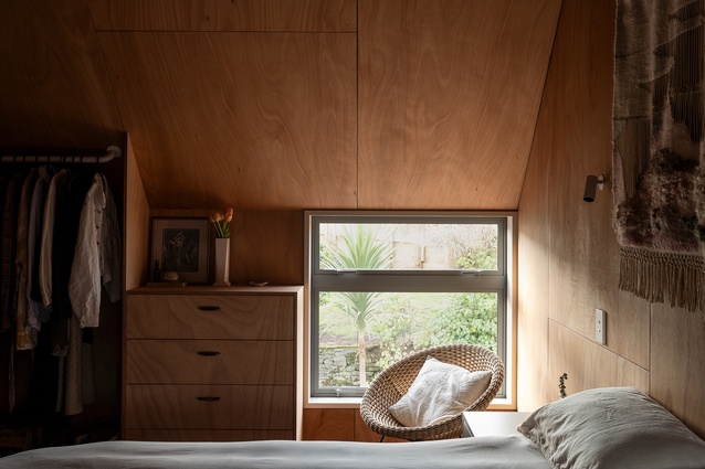 The main bedroom with it's built in cabinetry, plywood lining, and picture frame windows.
