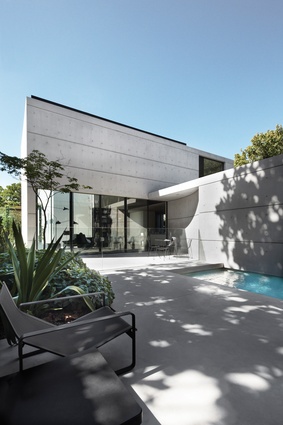 The new concrete, glass and dark steel wing has the same elegant intricacy as the original villa.