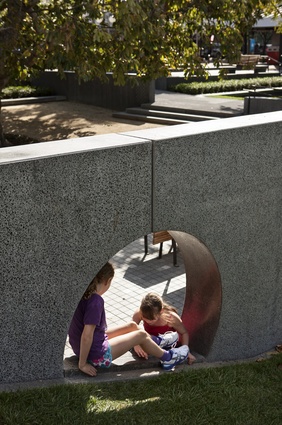 A circular cut-out in a dividing and retaining wall proves a popular place for impromptu play. 