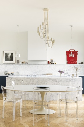 Dining table is by Eero Saarinen for Knoll, chairs are La Marie by Philippe Starck for Kartell, the centrepiece is by Erwan and Ronan Bouroullec, the chandelier is by Alain Richard.