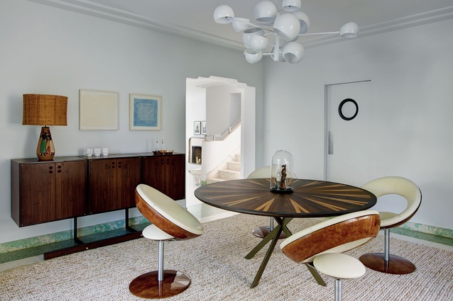 Brazilian vintage pieces (such as the circular Anel dining chairs) sit alongside contemporary European pieces.