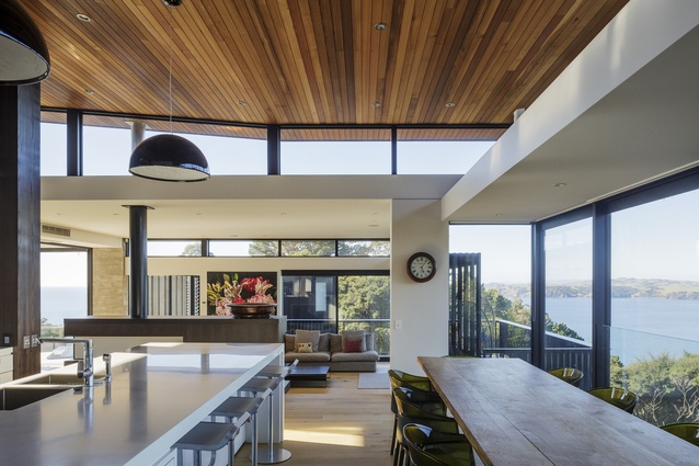 An open-plan living and dining area in the Onetangi House makes the most of the home's position overlooking the ocean.