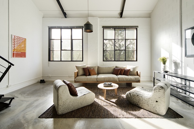 The serene living room is flooded with light, thanks to the large original windows.