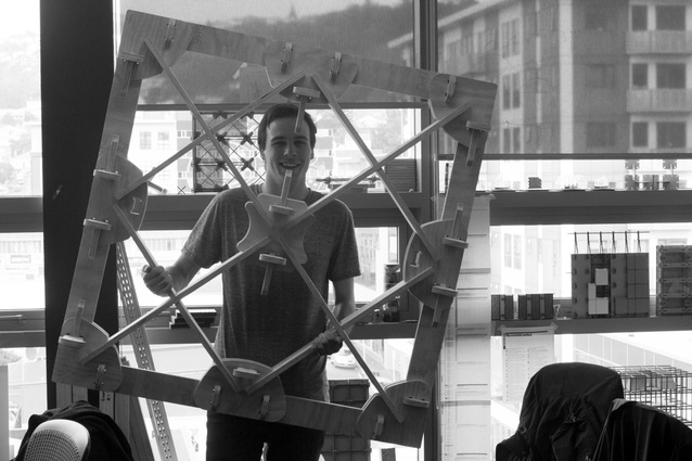 Ged Finch holding a 1:2 scale CNC-cut plywood prototype of the xFrame system.