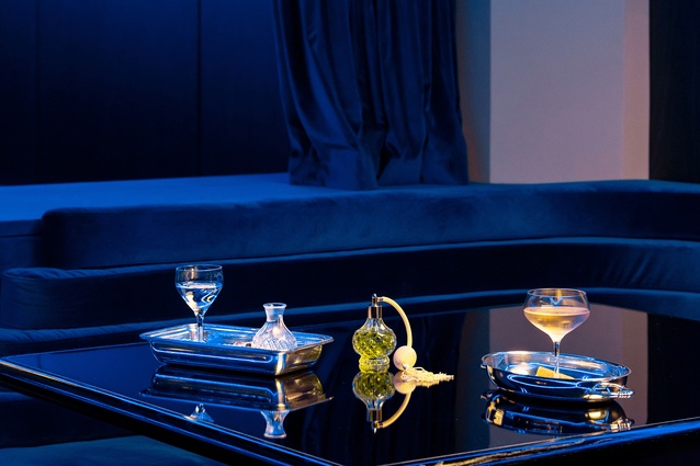Rich blue tones incorporated throughout upholstery, paint and lighting.