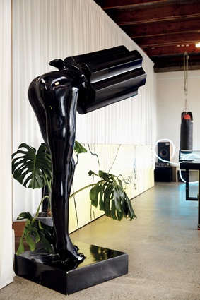Somewhere in this surrealist workplace there is also a life-sized, half-woman, half-revolver statue.
