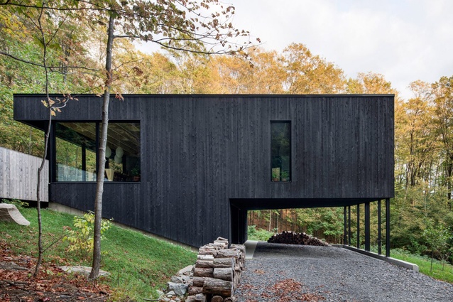 The Rock, Quebec, Canada, by Atelier General. 2017. The living room of this two-storey house is supported by slender columns that make space for a car port.