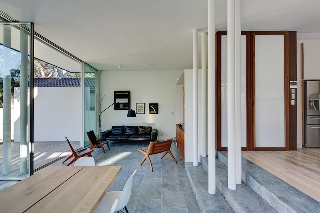 The rear spaces have an exaggerated informality, the timber poles replaced here by clusters of white metal poles.