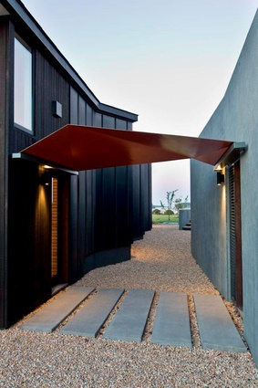 The house has been designed as separate pavilions to accommodate a growing family and guests.