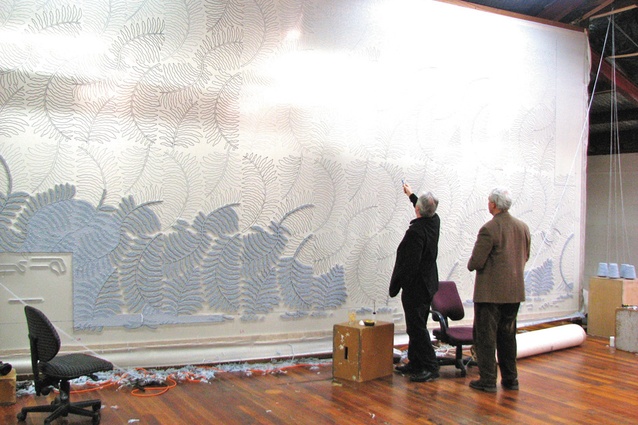 The artist inspecting a scaled up pattern.