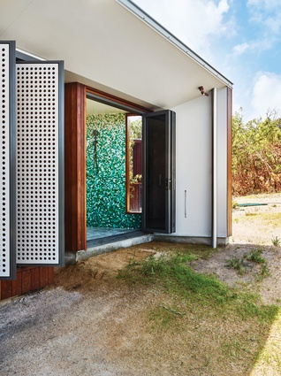 A colourful mosaic-tiled indoor/outdoor bathroom makes the most of its remote location.

