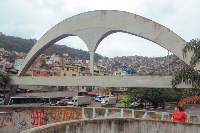 A sweeping concrete footbridge designed by Oscar Niemeyer marks the entry to Rocinha.