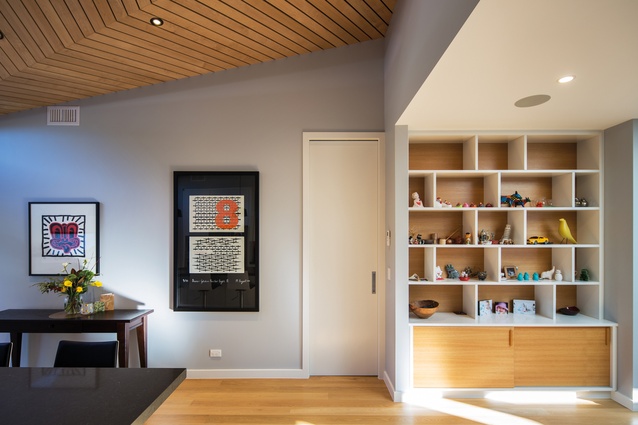 Custom-built cabinetry provides spaces to display special objects. The flooring is white oak. 