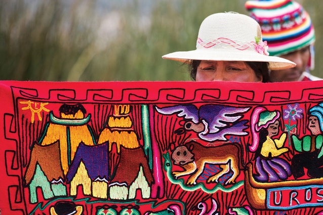 Woman holding traditional Peruvian textile arts, one of the main inspirations for the interior.