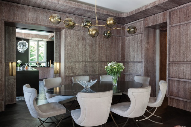 The dining room features limed and varnished oak panelling, a Branching Bubble chandelier by Lindsey Adelman, a Knoll Saarinen marble table and Paloma Baxter chairs by Roberto Lazzeroni.