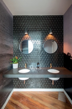 The mens room is dark and brooding, with a touch of classic luxury.