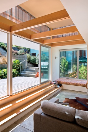 The double-height living space steps up into the patio and garden.

