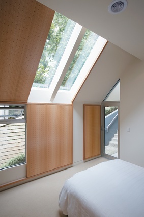 Bedroom on the south side of the middle level, with custom window screens.
