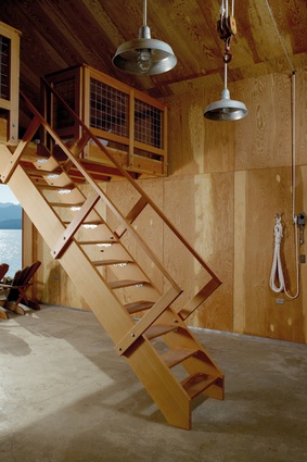 Marine ply interior walls create a warm, cabin-like feel for guests, who can retreat up the retractable stair.