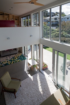 The double-height living area has a casual lounge above for the children, but is still open to allow for communication with the parents downstairs.