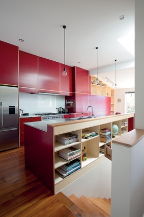 Atelierworkshop has used coloured plywood – which has colour actually embedded in the fibre of the wood – for the bold red kitchen.