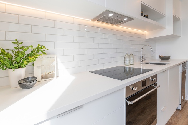 The kitchens feature Artisan engineered stone benchtops, tiled splashbacks and Methven tapware.