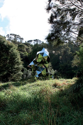 The 2km sculpture trail winds through a landscape framed by towering native trees, showcasing an ever-changing exhibition of contemporary sculptures.