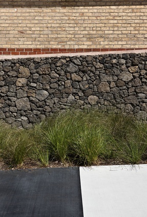 Material detail: stone walls, swales and coloured concrete.