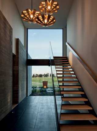 In the entry circulation space, windows capture selected views of the rural landscape.