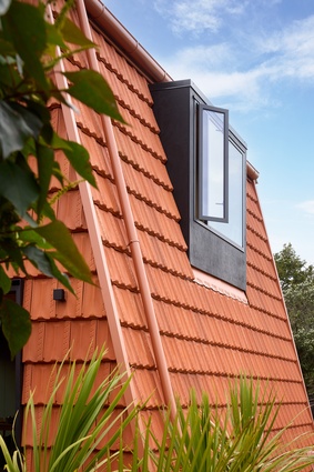 A dormer window is built into the raked exterior wall.