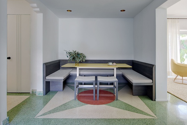 A dining nook with original colourful terrazzo flooring.